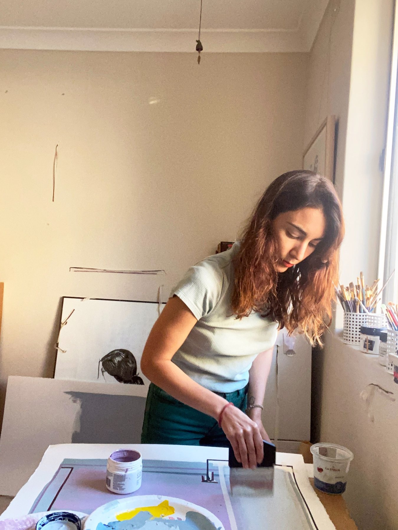 Rosa Lopez painting in the studio